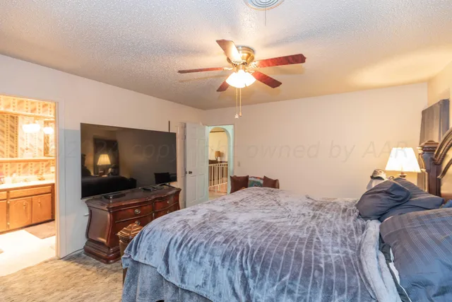 a bedroom with a bed couch and window