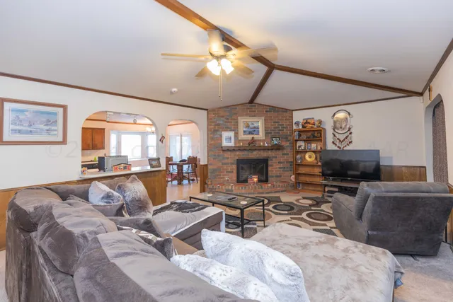 a kitchen with stainless steel appliances kitchen island granite countertop a refrigerator a stove a sink dishwasher with a dining table and chairs