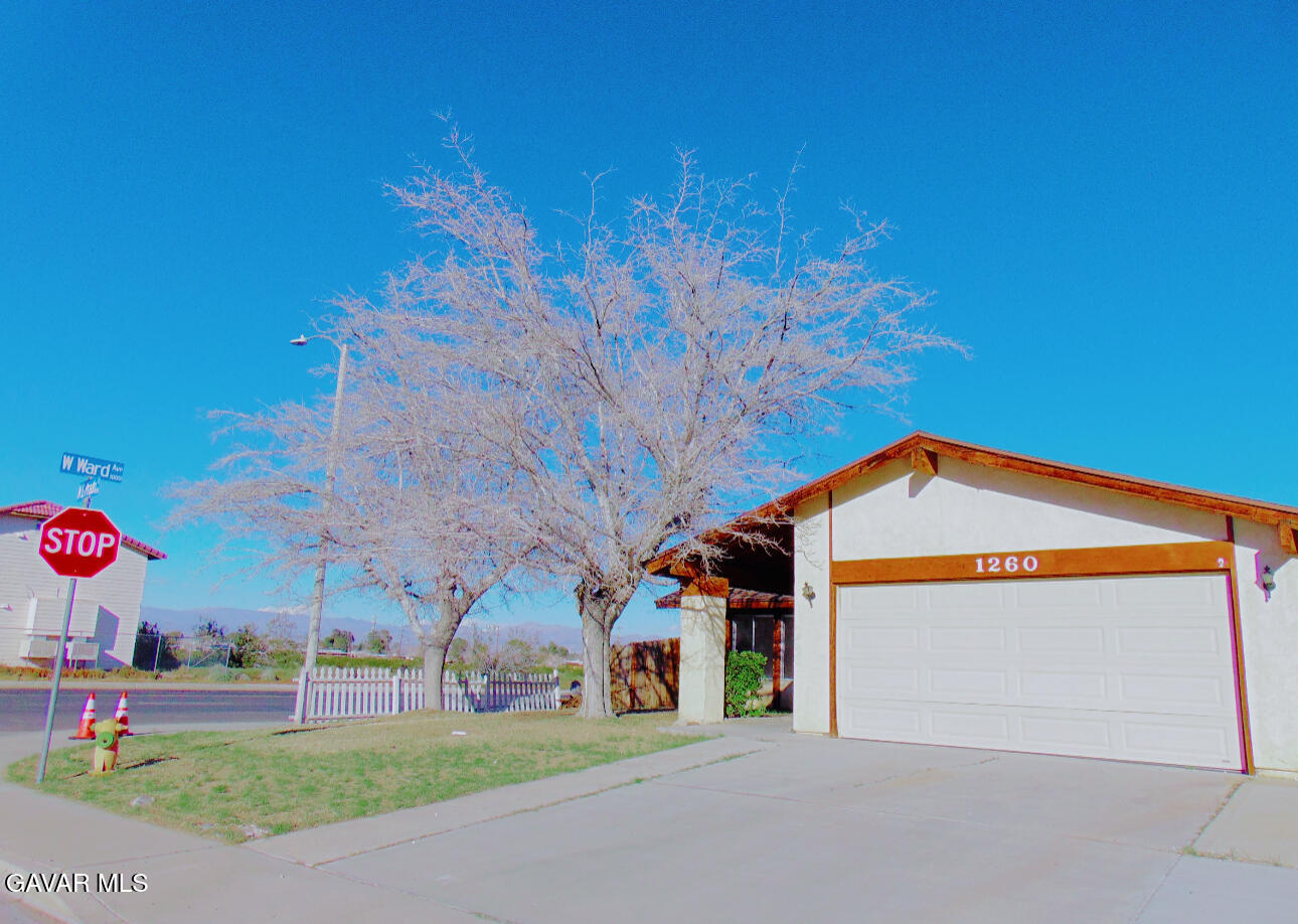 1260 North El Prado Street Ridgecrest, CA 93555 - Photo 1 of 28 a front view of a house with a yard and garage