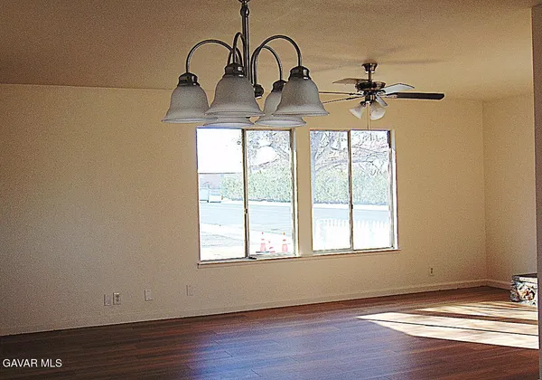 a view of a room with wooden floor and window