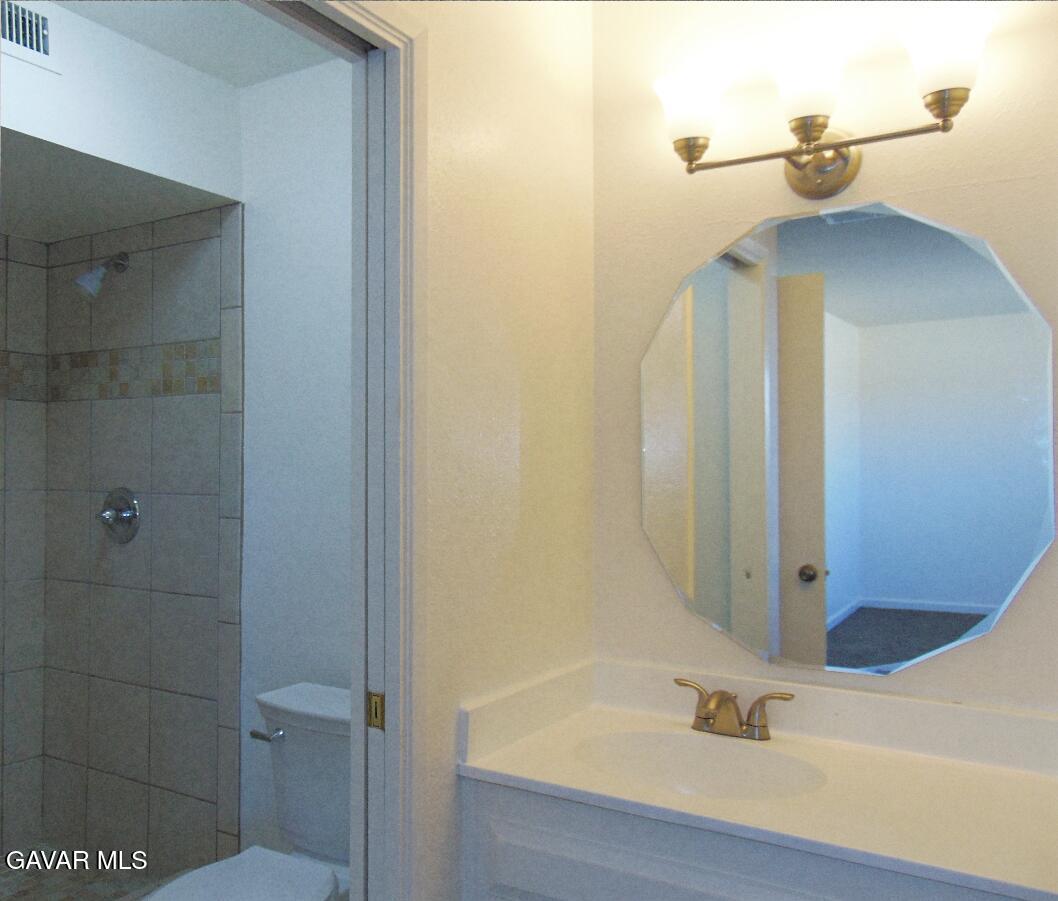 1260 North El Prado Street Ridgecrest, CA 93555 - Photo 18 of 28 a bathroom with a shower and a sink