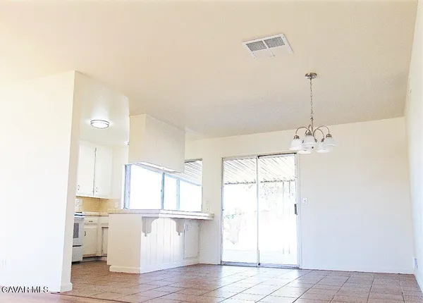 a view of a kitchen with wooden floor and a window
