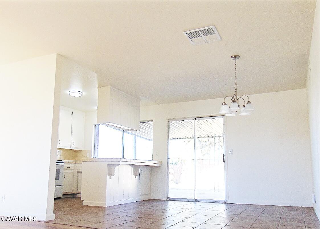 1260 North El Prado Street Ridgecrest, CA 93555 - Photo 3 of 28 a view of a kitchen with wooden floor and a window