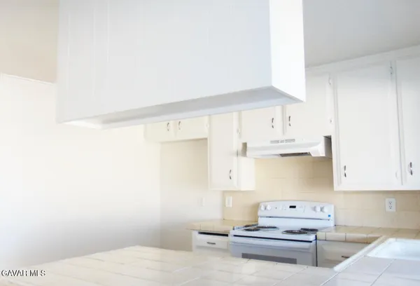 a living room with furniture and a kitchen