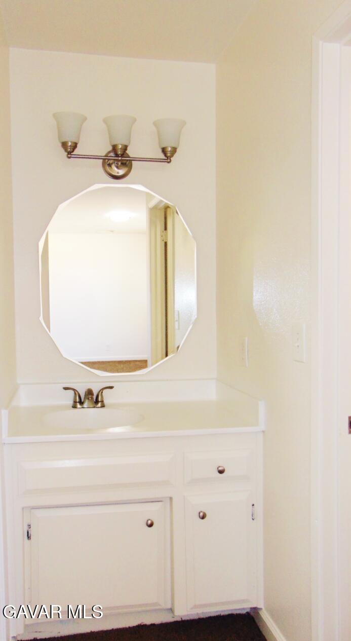 1260 North El Prado Street Ridgecrest, CA 93555 - Photo 9 of 28 a bathroom with a sink and a mirror