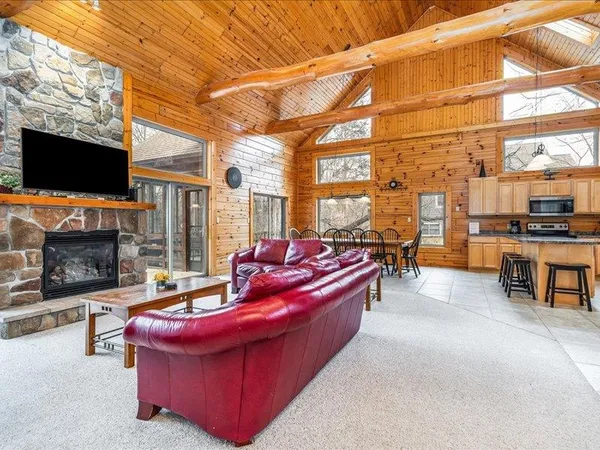 a living room with furniture a fireplace and a flat screen tv