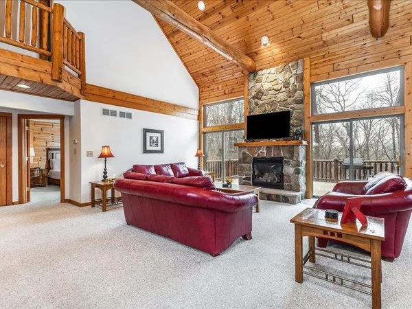 a bedroom with a bed dresser and a large window