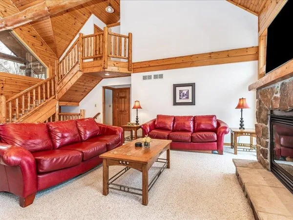 a living room with furniture and a floor to ceiling window
