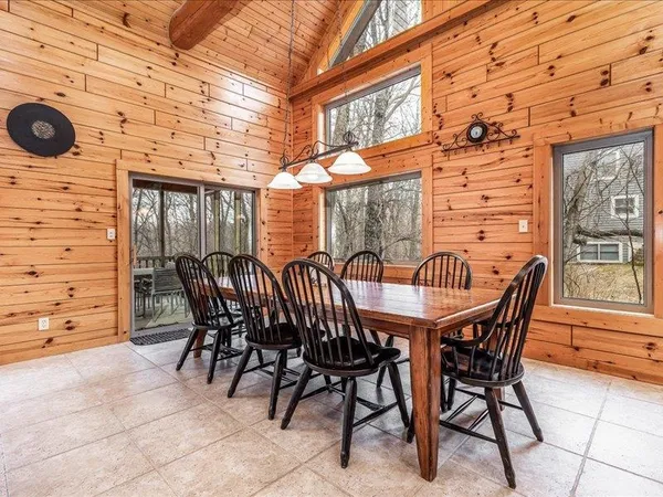 a bedroom with a bed and a lamp on the dresser
