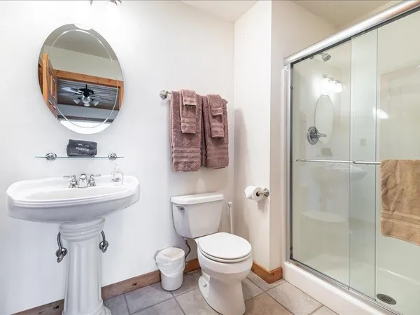 a bedroom with a bed and a dresser with a mirror