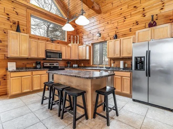 a kitchen with stainless steel appliances granite countertop a sink and cabinets