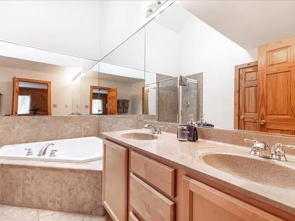 a view of a balcony with wooden floor and outdoor seating