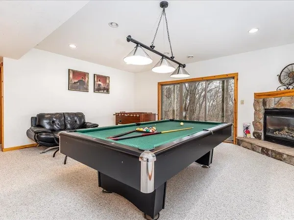 a view of a patio with a table chairs and wooden floor