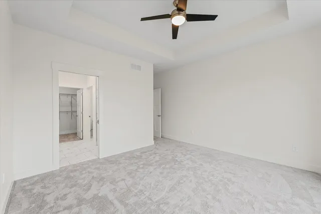 a view of a room with a ceiling fan