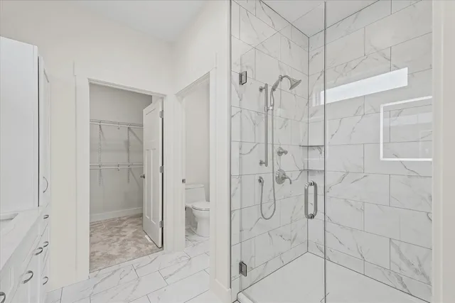 a bathroom with a shower and a glass door