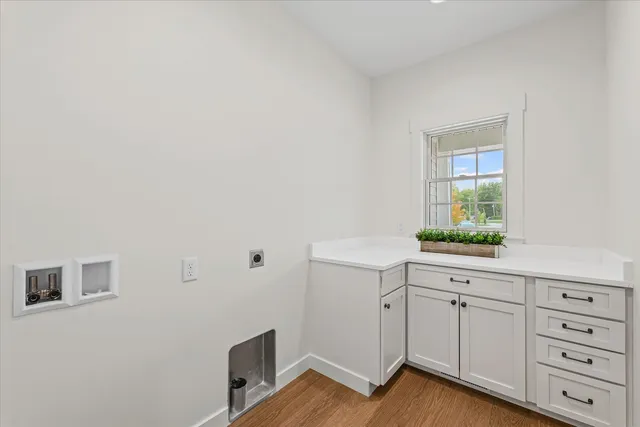 a kitchen with sink cabinets and wooden floor