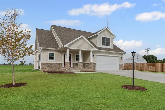 a front view of house with a garden and deck