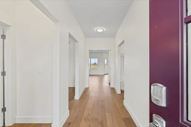 a view of a hallway with wooden floor