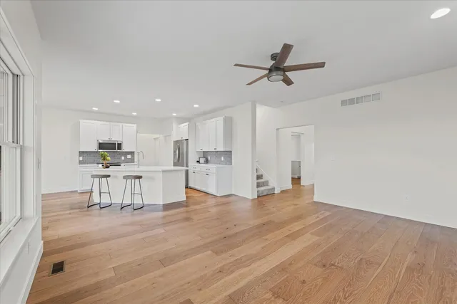 a view of kitchen with wooden floor and window