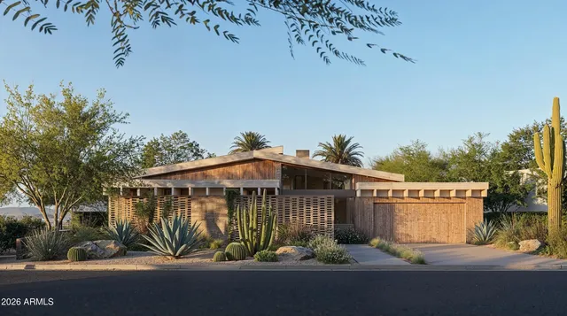 a view of a house with a yard and potted plants