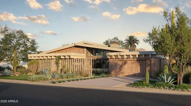 a front view of a house with a garden and pathway