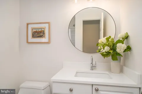 a bathroom with a sink mirror and vanity