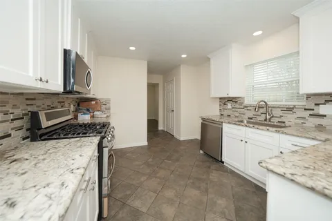 a view of a chandelier fan and refrigerator in a room