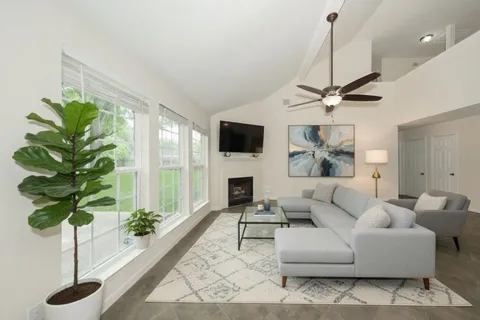 a bedroom with a large bed and a potted plant