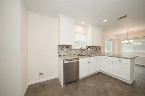 a kitchen with stainless steel appliances a stove sink and cabinets
