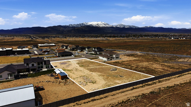 2930 Jojo Road, Unit 110 Eagle Mountain, UT 84005 - Photo 4 of 22 Aerial view of residential area featuring a mountain backdrop and property parcel outlined