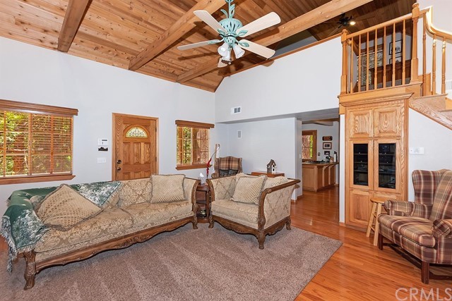 659 Blue Jay Canyon Road Blue Jay, CA 92317 - Photo 16 of 40 a spacious bedroom with a bed couch and a window