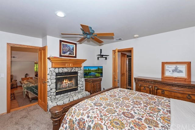 659 Blue Jay Canyon Road Blue Jay, CA 92317 - Photo 22 of 40 a bedroom with a bed and a fireplace