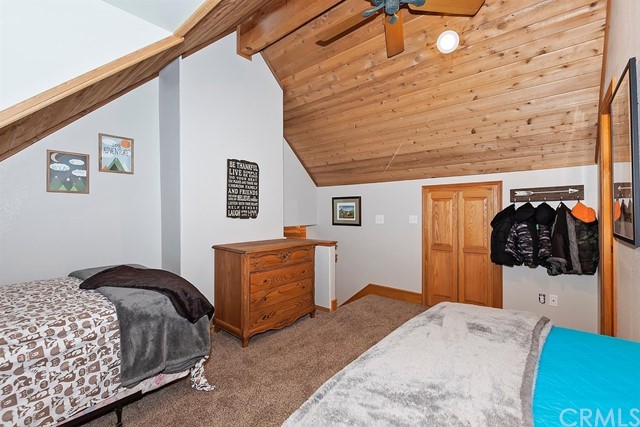 659 Blue Jay Canyon Road Blue Jay, CA 92317 - Photo 25 of 40 a bedroom with a bed and a dresser