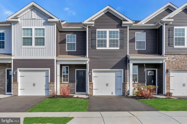 a front view of a house with garden and porch