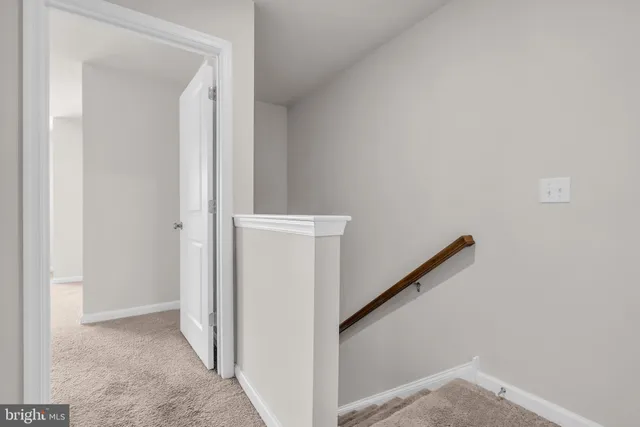 an empty room with windows and ceiling fan view