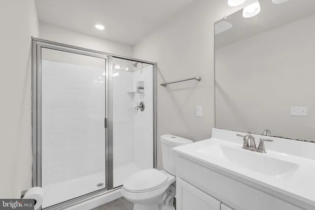 a bathroom with a sink vanity and a mirror