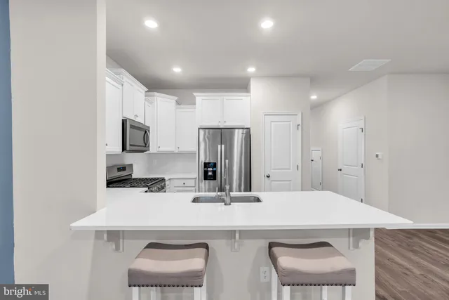 a kitchen with a sink stove and microwave