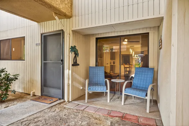 a view of a patio with table and chairs and potted plants