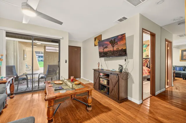 a view of a livingroom with furniture and a flat screen tv