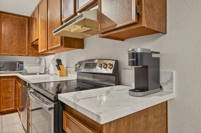 a kitchen with a stove a sink and a microwave
