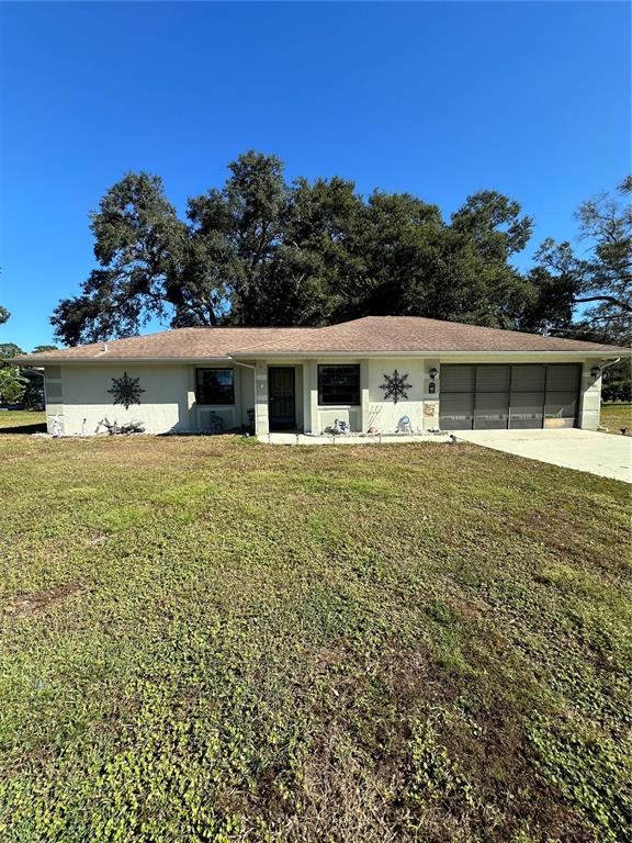9385 Hayward Road Spring Hill, FL 34608 - Photo 1 of 1 a view of a house with a yard