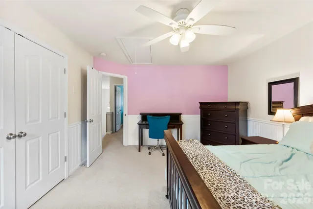 a bedroom with a bed a dresser and a book shelf