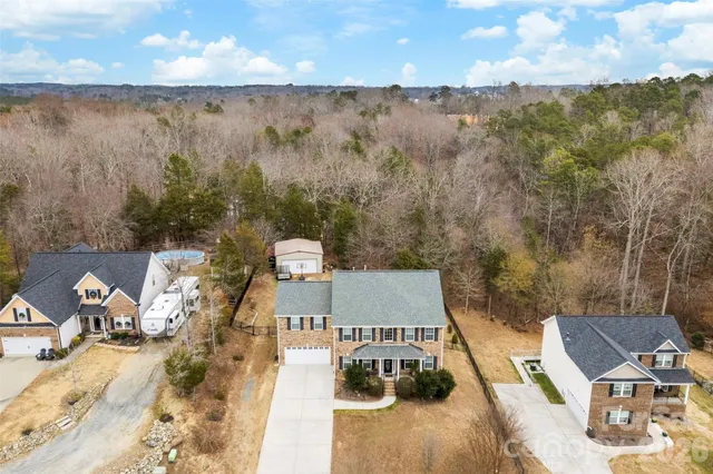an aerial view of a house with yard
