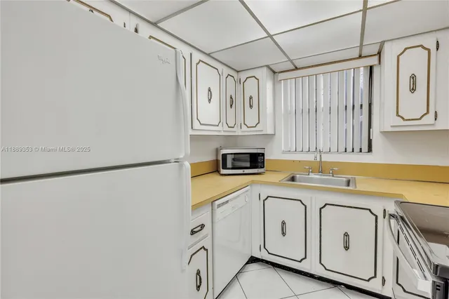 a kitchen with appliances cabinets and a counter top space