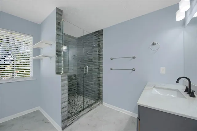 a bathroom with a shower and a sink