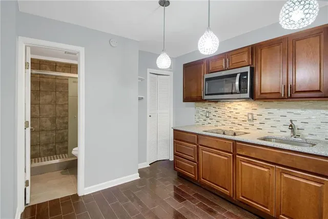 a kitchen with stainless steel appliances granite countertop cabinets and wooden floor