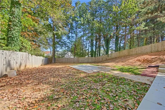a view of backyard space with large trees