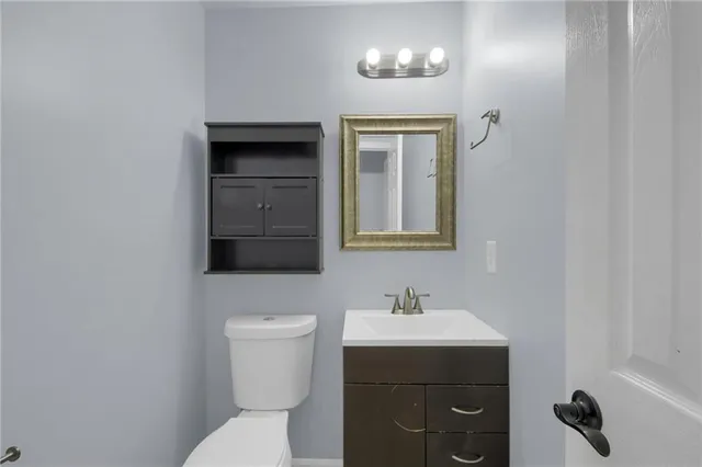 a bathroom with a toilet sink and mirror