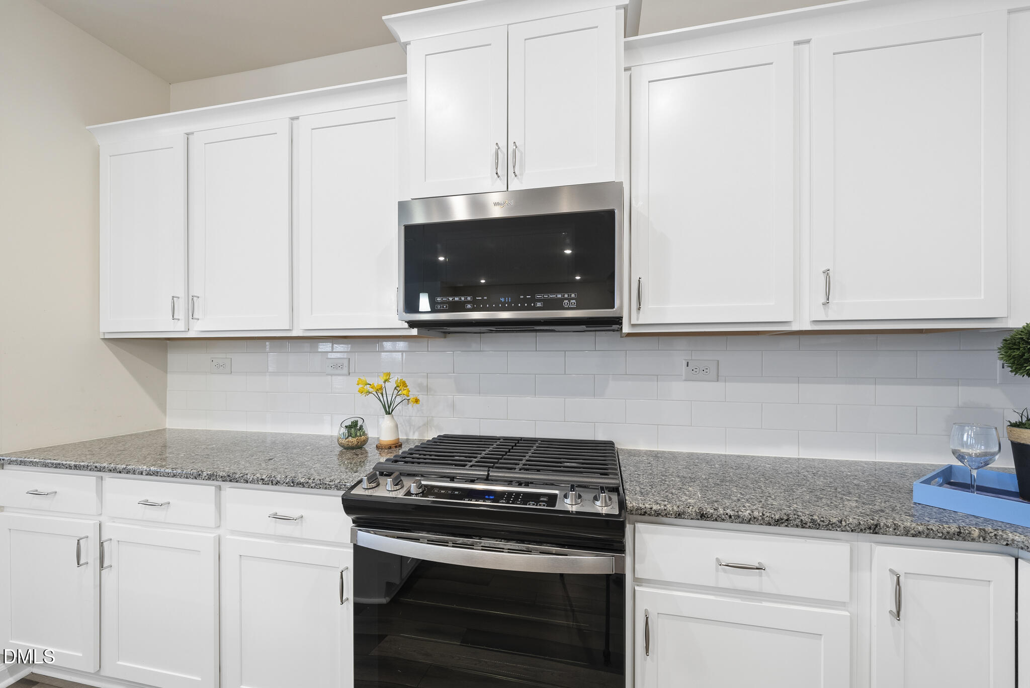 1012 Citadel Avenue Durham, NC 27713 - Photo 12 of 34 a kitchen with granite countertop white cabinets and stainless steel appliances