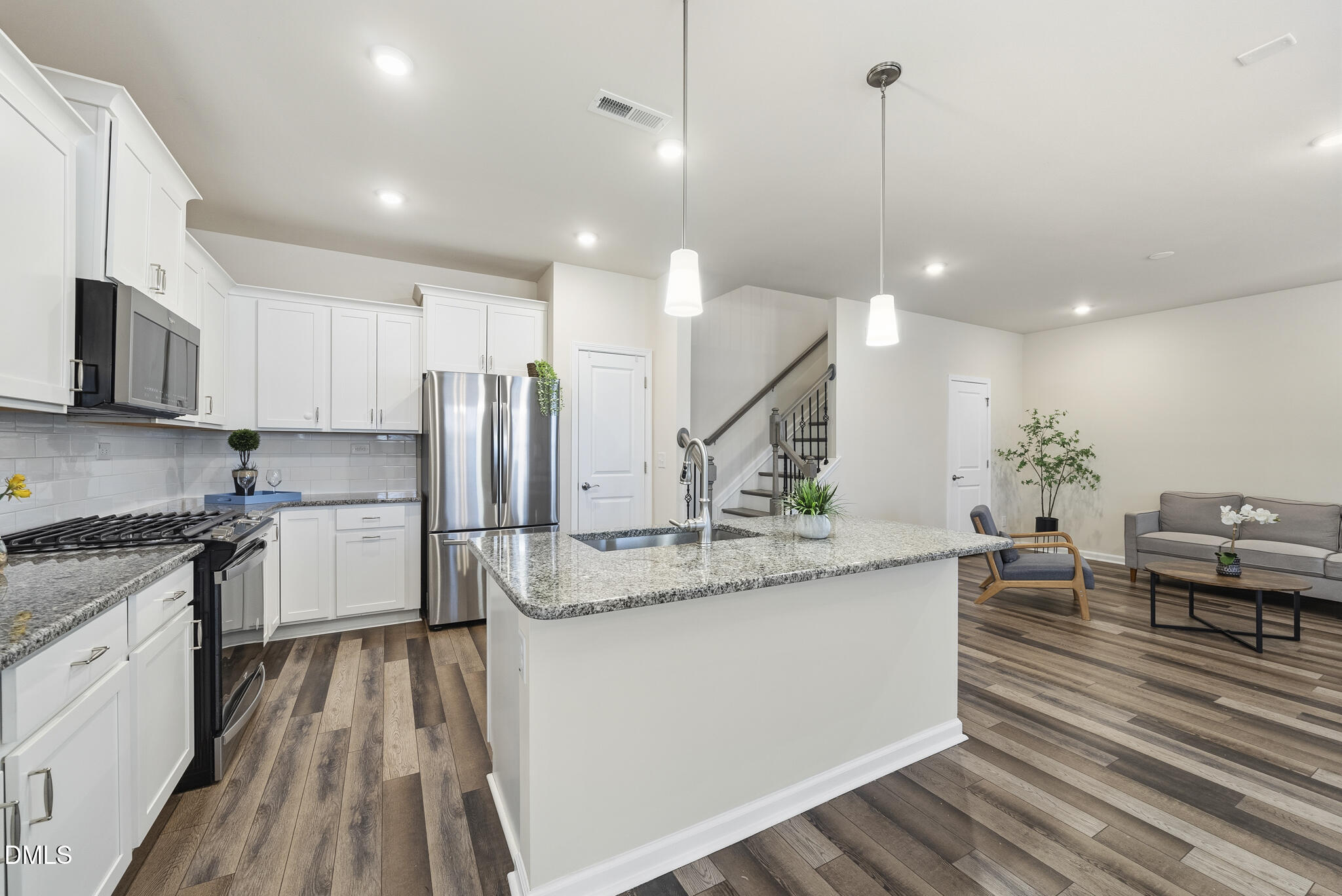 1012 Citadel Avenue Durham, NC 27713 - Photo 14 of 34 a kitchen with stainless steel appliances granite countertop a sink a stove and a wooden floors